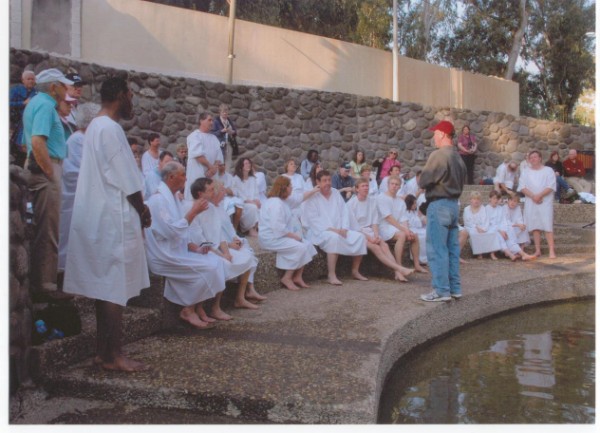 TIM SHARING WITH HIS GROUP BEFORE THE JORDAN RIVER BAPTISMS.